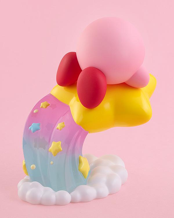 Rear studio view of the Kirby figure highlighting his red feet, round pink shape, and the detailed pastel gradient trail embedded with star graphics.