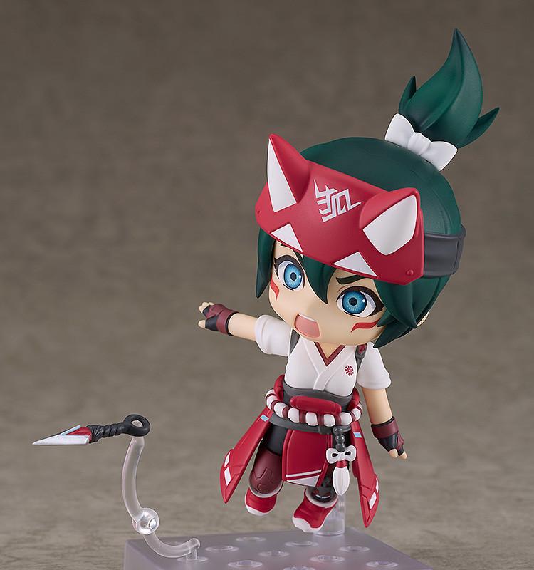 Action pose of the Kiriko Nendoroid figure featuring her combat face plate with blue glowing eyes as she throws a kunai dagger on a clear plastic effect piece.
