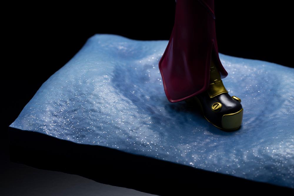 Textured look at the sparkling snowy field diorama base of the Kotobukiya Kula Diamond statue under moody directional spotlighting.