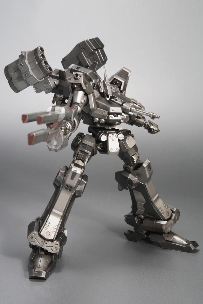 Dynamic low-angle perspective shot of the Armored Core Crest CR-C90U3 model kit pointing its long handheld railgun directly toward the camera lens.