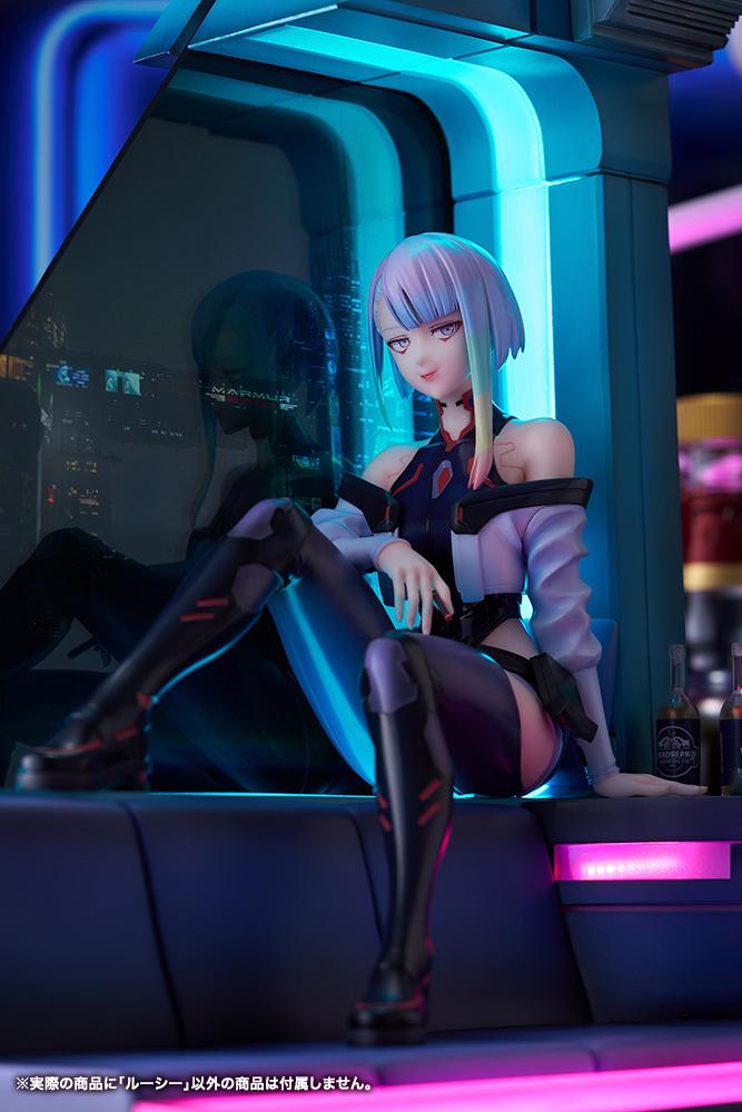 Vertical medium portrait of Lucy under moody blue neon light with glass reflection.
