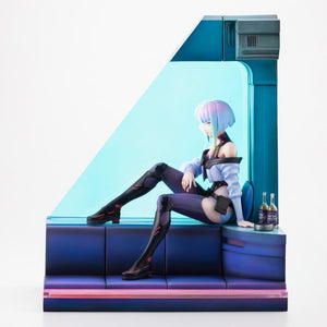Front side view of Lucy figure seated on blue room diorama sofa showing signature outfit and Broseph bottles.
