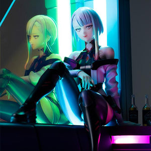 Low-angle close-up of Lucy figure under atmospheric cyan and green neon LED lighting.