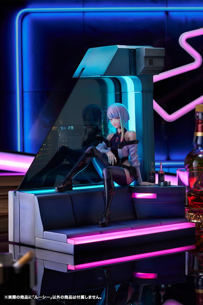 Atmospheric diorama scene of Lucy figure displayed in a cyberpunk room setting with neon bar lighting.