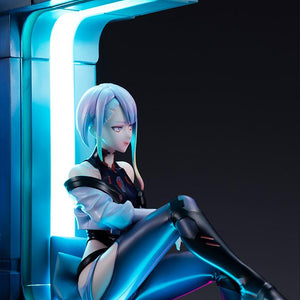 Right profile angle of Lucy resting on window couch illuminated by vertical cyan neon LED strip.
