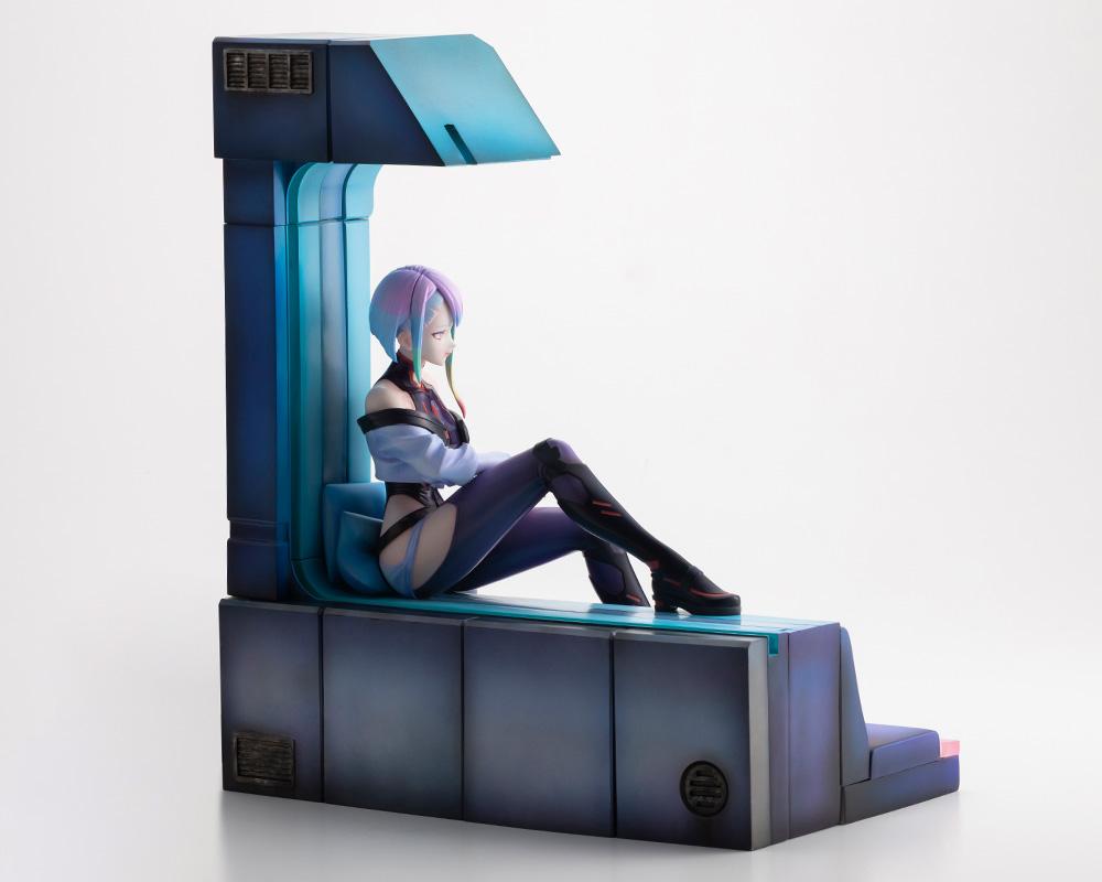 Right side profile perspective of Lucy 1/7 scale figure seated by the room window column structure.