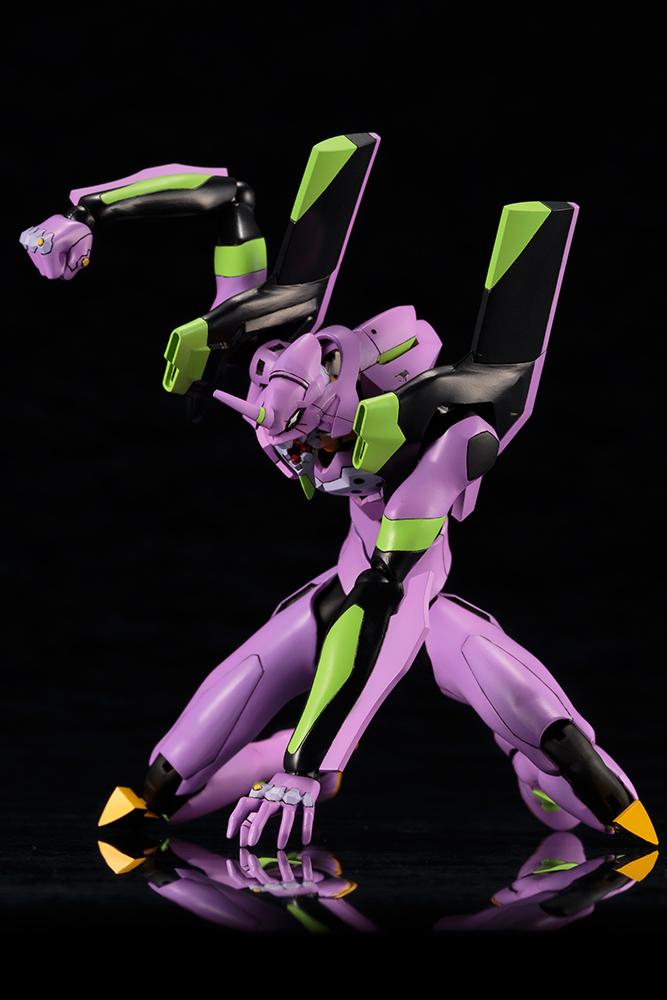 Highly articulated Kotobukiya Evangelion EVA-01 Test Type model kit executing a dynamic three-point ground landing pose.