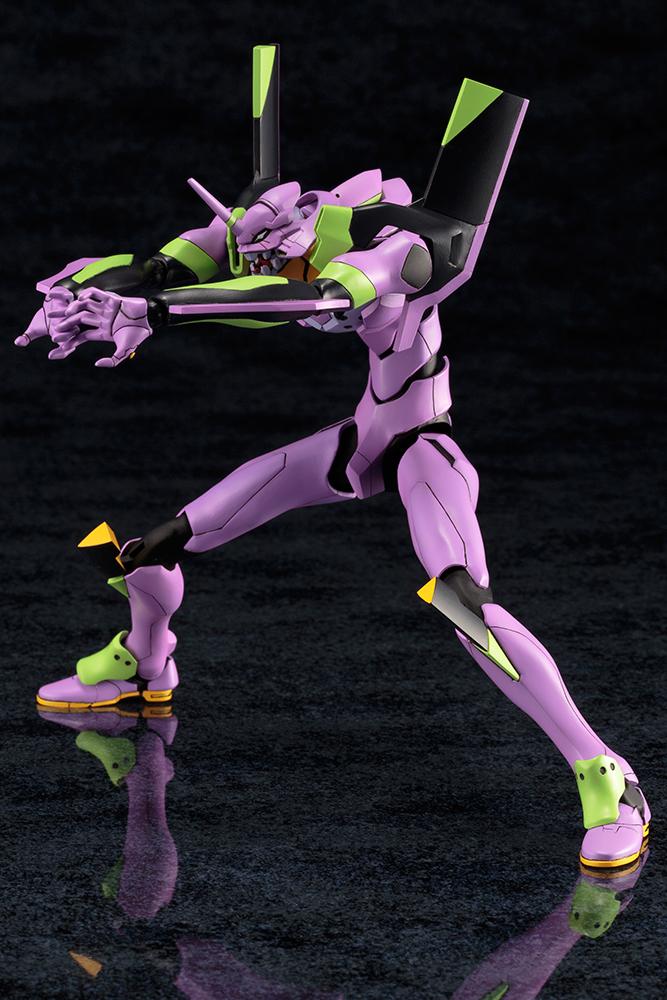 Dynamic action pose of Kotobukiya EVA-01 Test Type model kit charging forward with open hands against a dark background.
