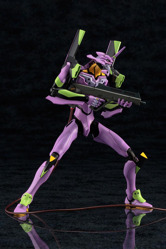 Standing combat ready pose of the Kotobukiya Evangelion EVA-01 model kit holding the Pallet Rifle weapon with the umbilical cable attached.