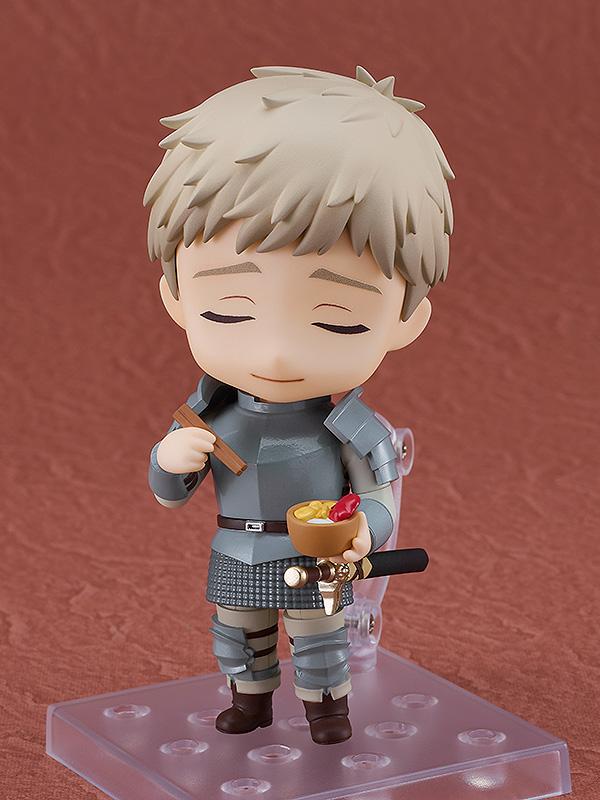 Laios Nendoroid with eyes closed enjoying a bowl of scorpion hotpot while holding chopsticks.