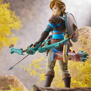 Rear view of Link figma holding the Construct Bow and wearing the Hylian Shield in a detailed landscape setting.