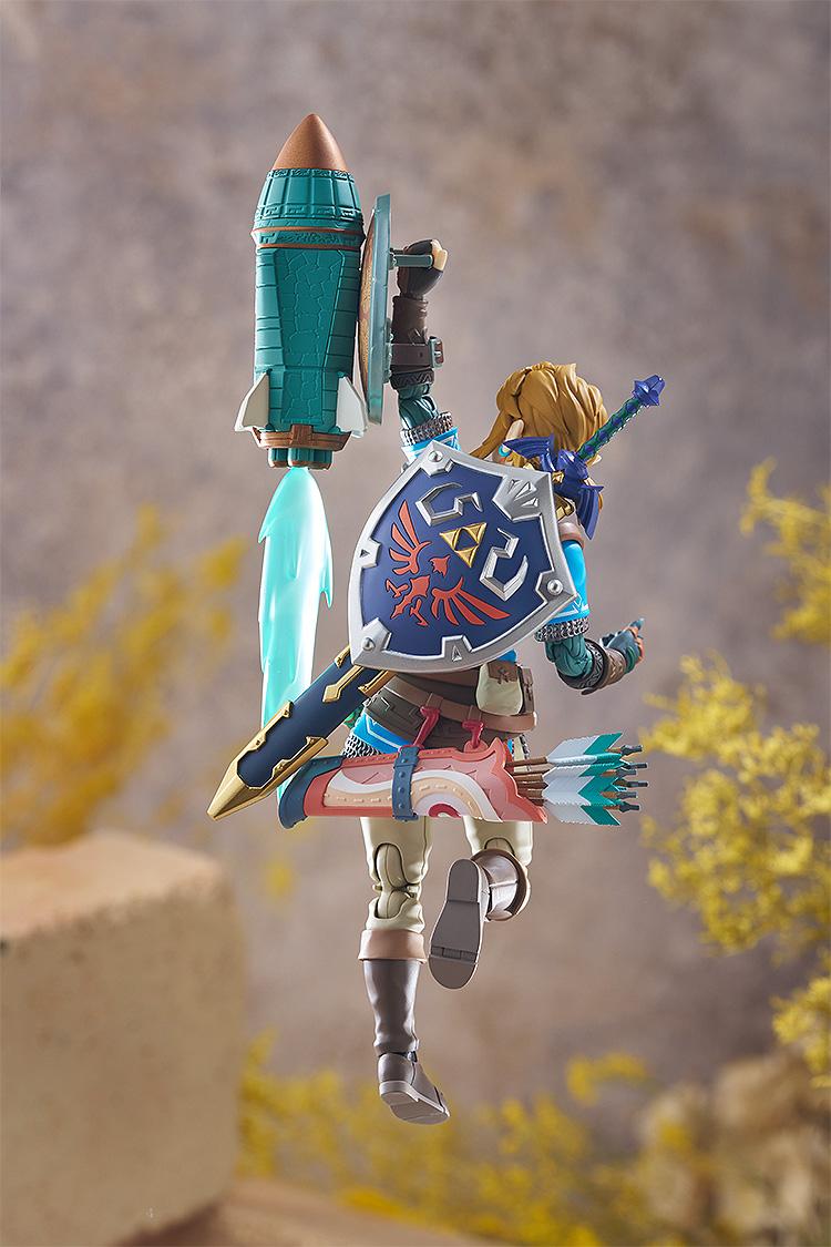 Rear action shot of Link using the Rocket fused to his shield to launch upwards, featuring translucent blue flame effects.