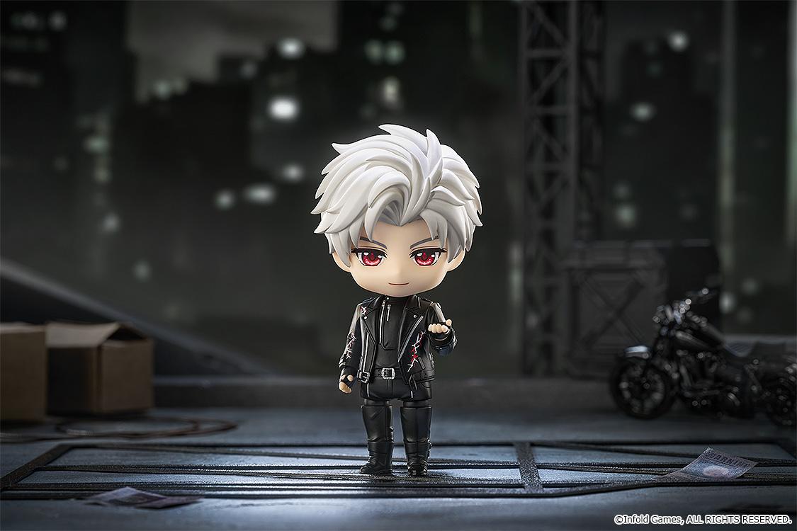 Sylus Nendoroid figure posed in a dark city alleyway diorama scene next to a miniature motorcycle.