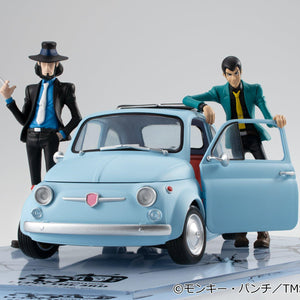 Close-up front view of Lupin in green jacket leaning on the ice blue vehicle door.