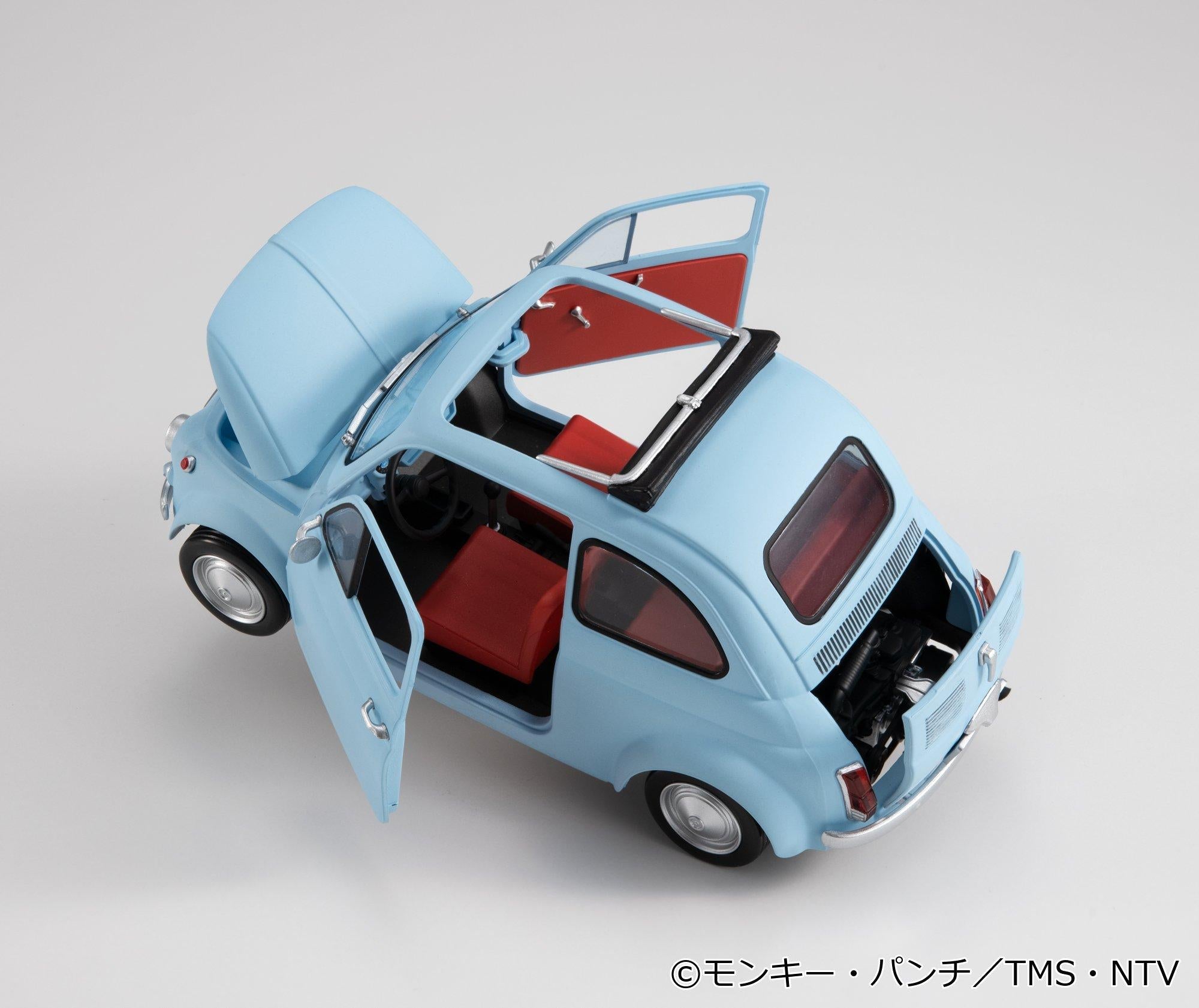 Top-down overhead view of the ice blue car with open hood, doors, sunroof, and red interior.
