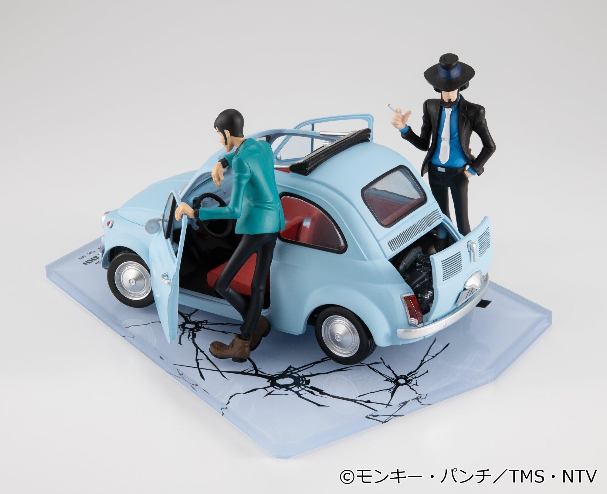 Rear elevated view of the 1/20 scale ice blue car showing open engine hatch alongside figures.