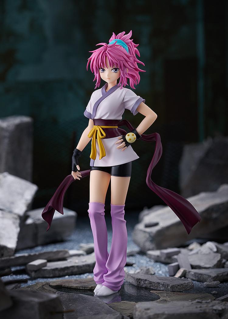 Full view of the Machi collectible figure posed against a dark, urban ruins diorama background.