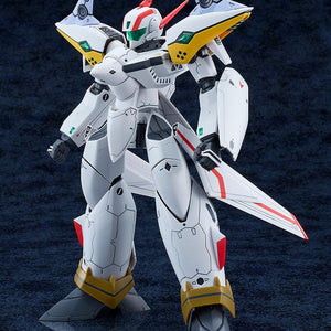Left three-quarter standing view of the assembled Macross Dynamite 7 VF-19P Excalibur mecha, showcasing its sleek armor lines and shoulder-mounted space-time resonance speaker units.