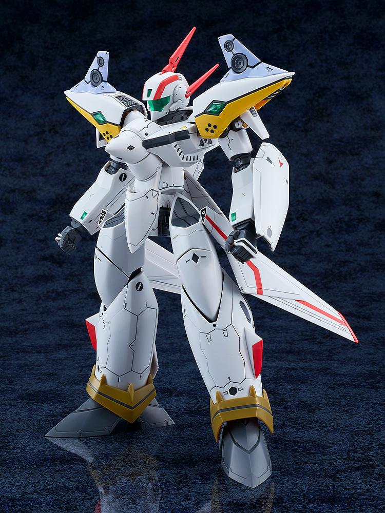 Left three-quarter standing view of the assembled Macross Dynamite 7 VF-19P Excalibur mecha, showcasing its sleek armor lines and shoulder-mounted space-time resonance speaker units.