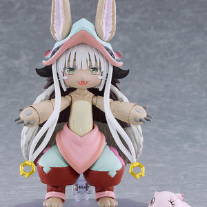 Full front view of the articulated figma Nanachi figure standing on a clear display base with the sleeping Mitty companion figure at her feet.