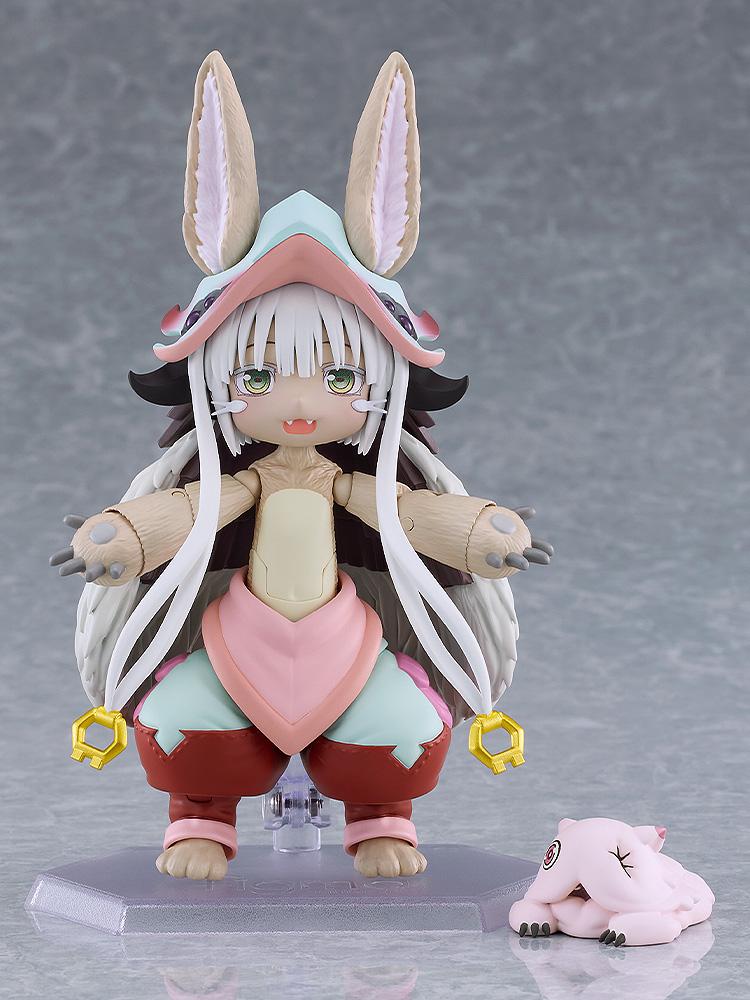 Full front view of the articulated figma Nanachi figure standing on a clear display base with the sleeping Mitty companion figure at her feet.