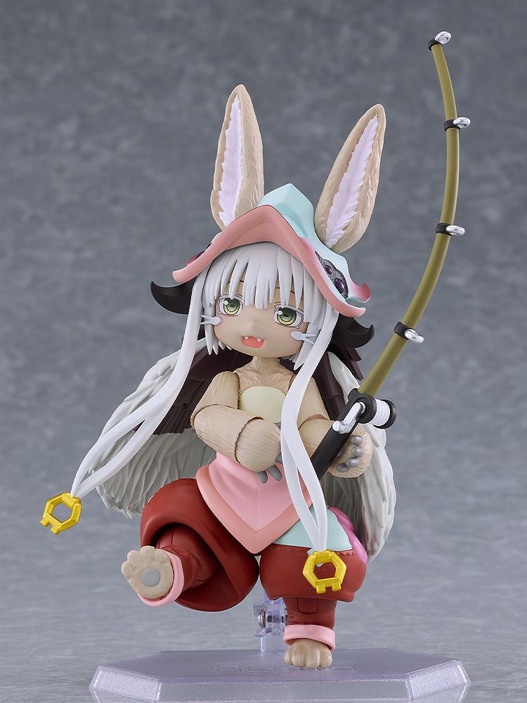 Action pose of the figma Nanachi figure holding the curved fishing rod accessory on a clear display stand.
