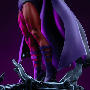 Close-up detail shot of the Magneto statue's boots, muscular leg sculpting, and the swirling metallic debris base illuminated by dramatic purple studio lighting.