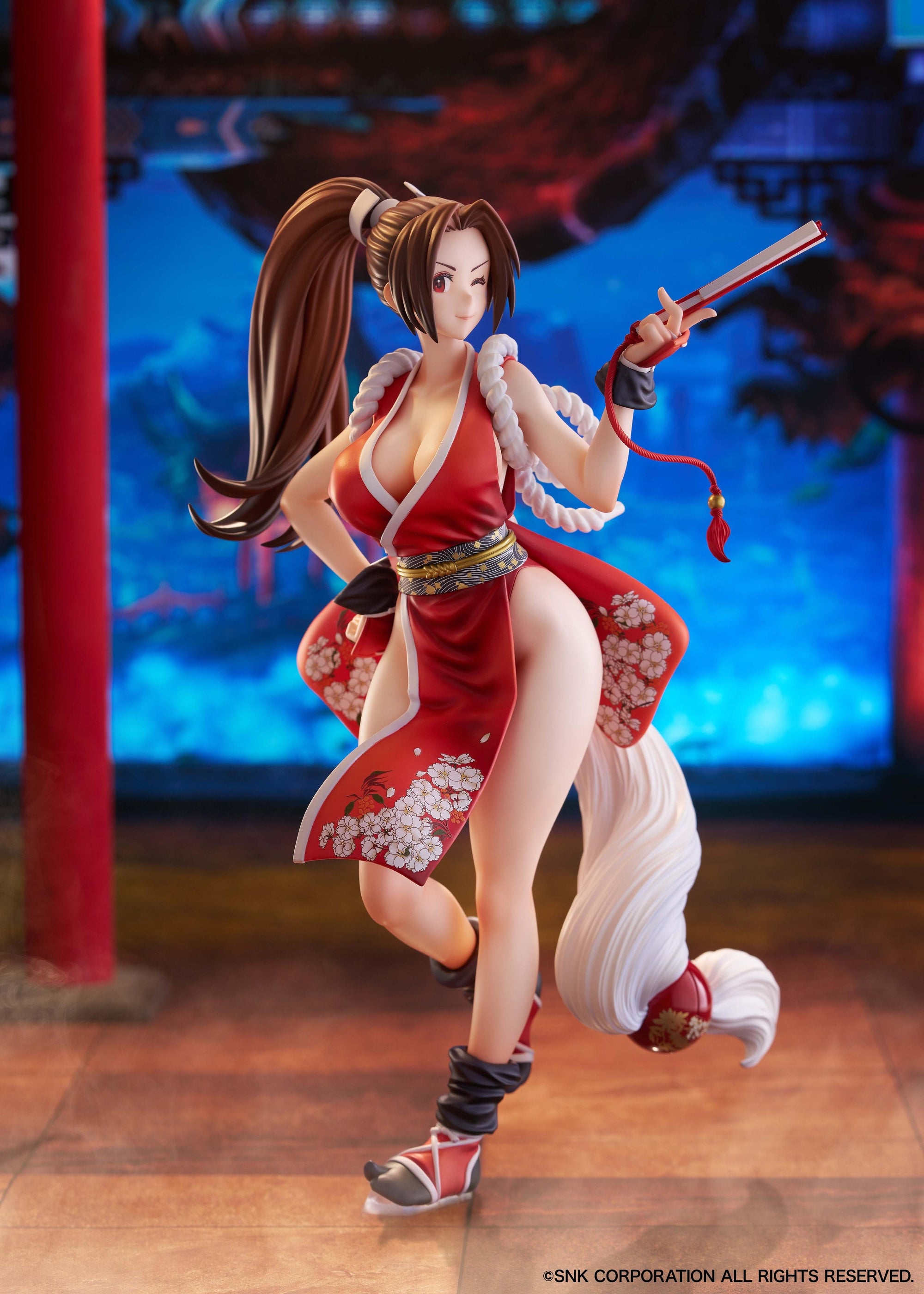 Full body shot of Mai Shiranui 1/7 scale figure with winking face in a traditional Japanese temple setting.
