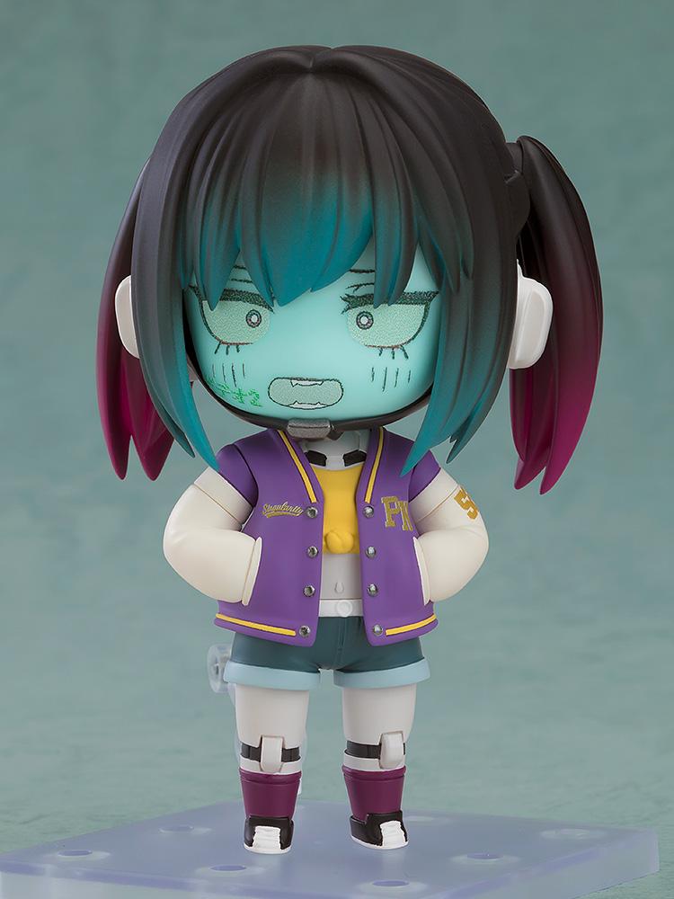 Makina Nendoroid showing a panicked face plate with a jagged mouth and wide eyes, standing with hands behind her back.