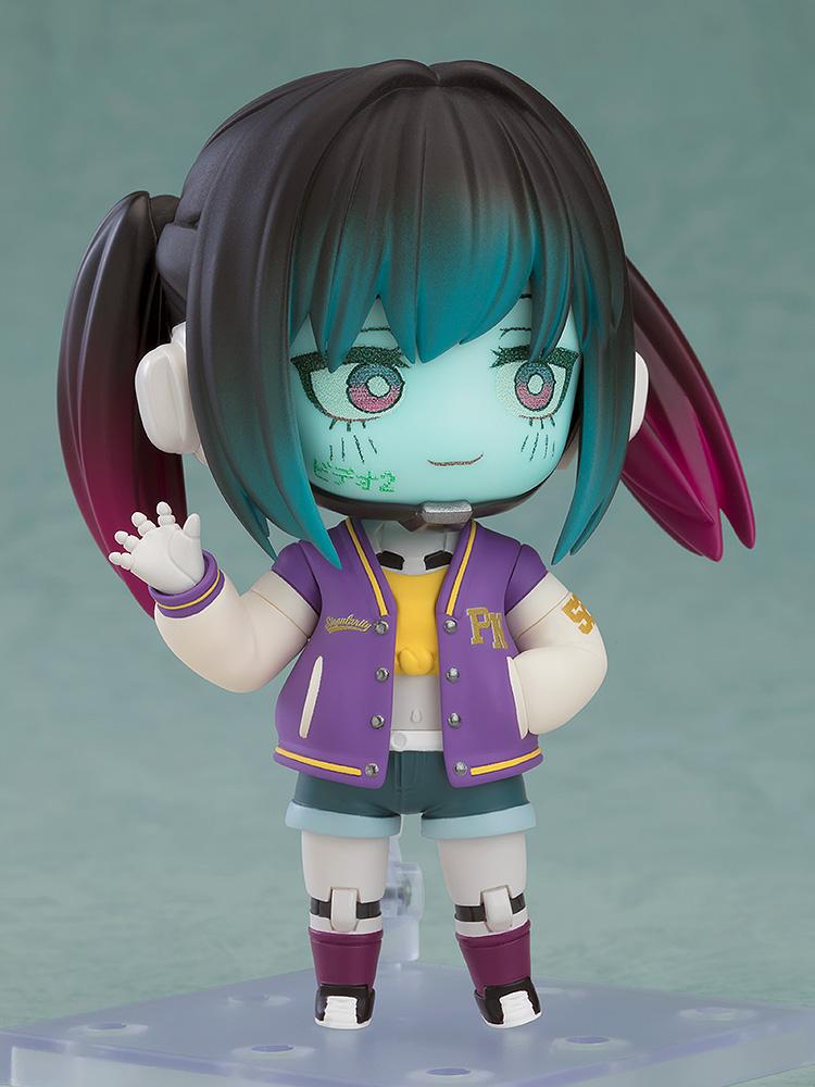 Makina Nendoroid with a subtle smiling face plate and a waving hand gesture on a clear display stand.