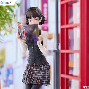 Close-up shot emphasizing the colorful magazine cover and Makoto Niijima's focused reading expression outdoors.