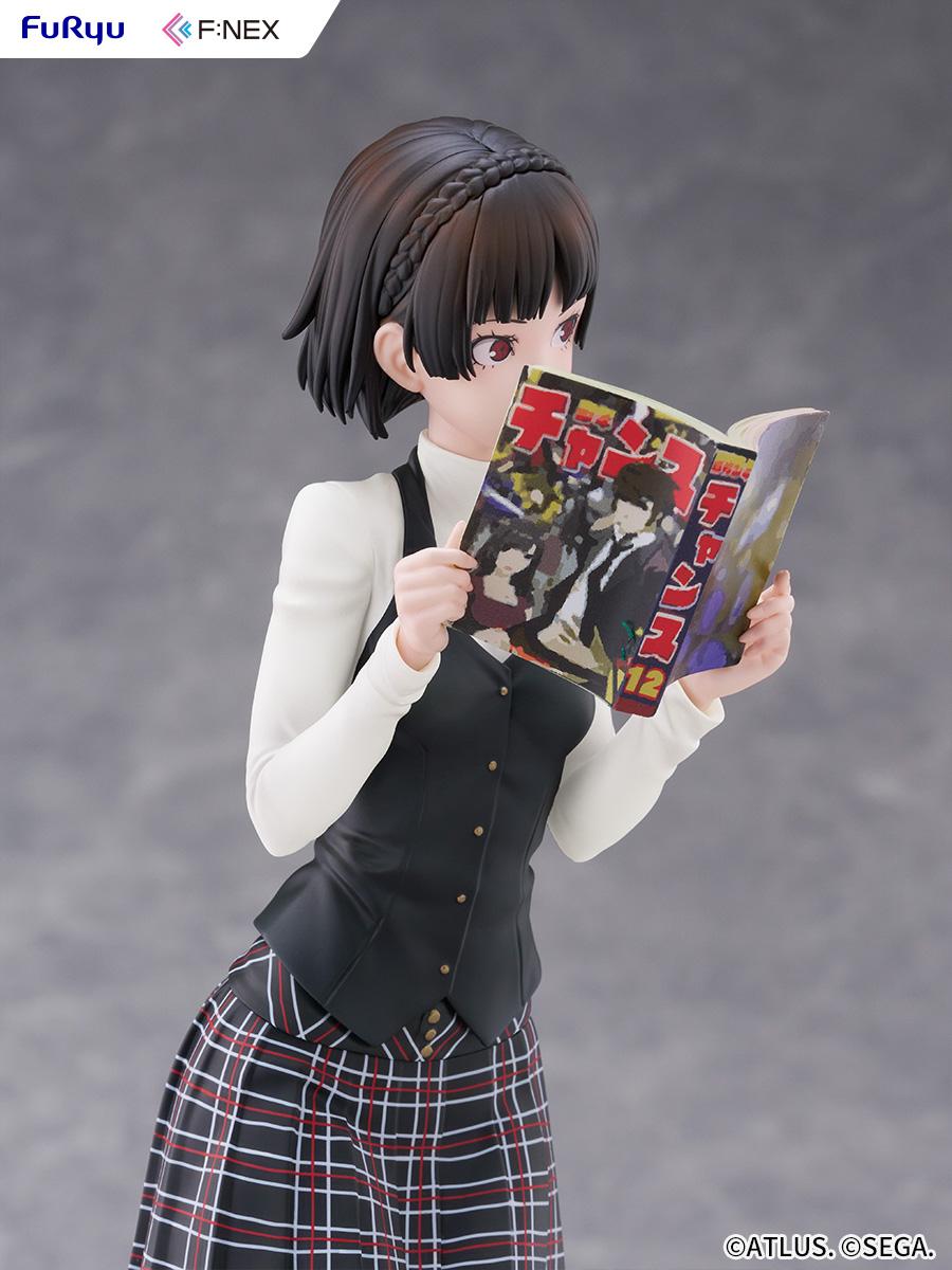 Angled upper-body close-up of Makoto Niijima holding the open Monthly Shonen Chance magazine.