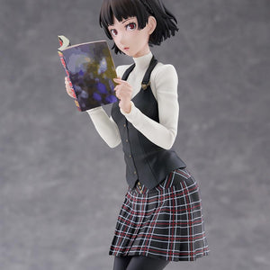 Waist-up shot of Makoto Niijima in her black vest and white turtleneck holding open a colorful manga magazine.