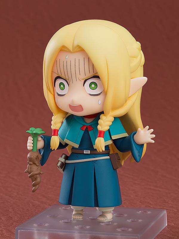 Articulated Marcille Nendoroid with a comical screaming face plate while holding a crying Mandrake root accessory.