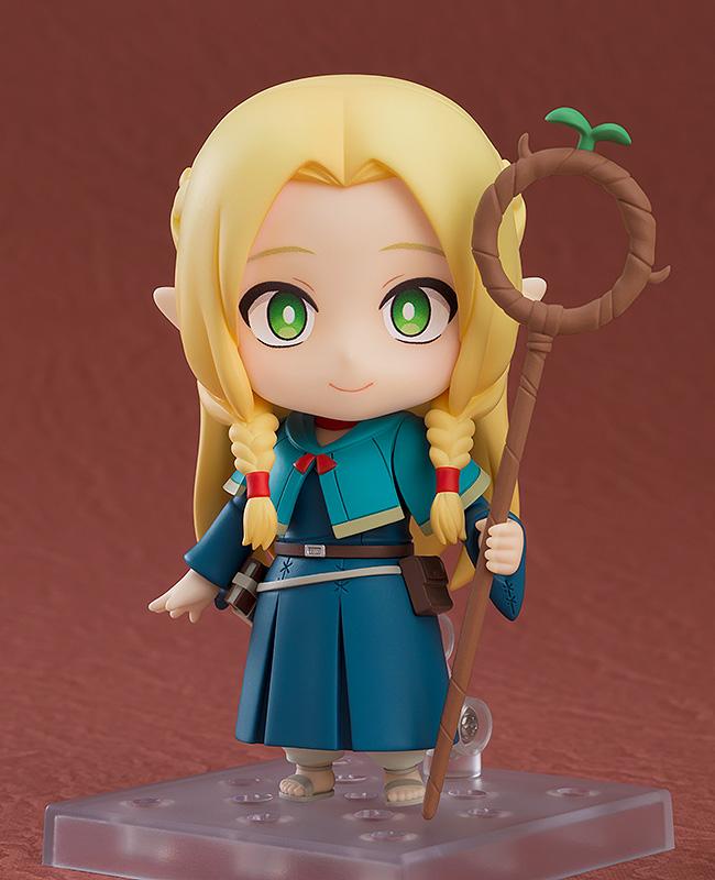 Marcille Nendoroid displayed on a stand with a gentle smiling face plate, holding her signature wooden staff, Ambrosia.