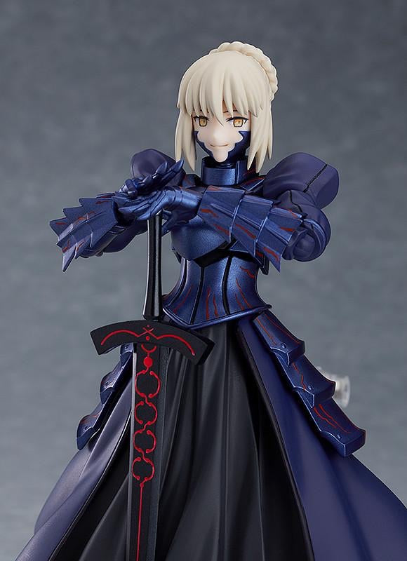The Saber Alter figma figure featuring the closed-eyes smiling expression face plate, contrasting with her dark armor.