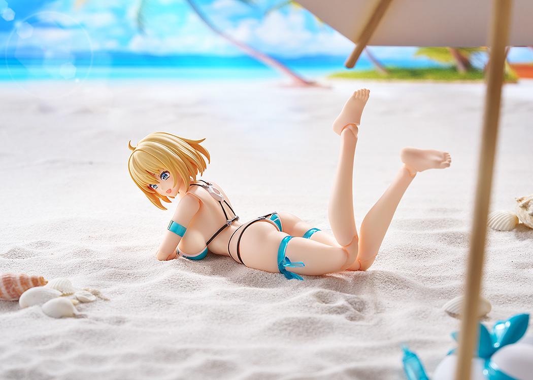 Sophia F. Shirring figma posed laying on her stomach on white sand under a beach umbrella, displaying the interchangeable bare feet.