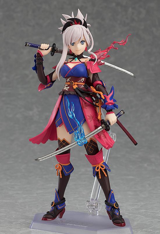 The Miyamoto Musashi figma figure in a ready stance, showing both swords and the vibrant blue and red energy effects unique to her figure.