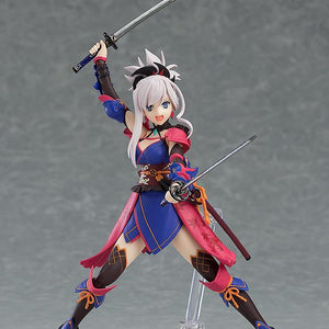 Miyamoto Musashi figma figure in a dynamic action pose, holding both katana swords above her head and smiling confidently.