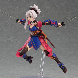 The Miyamoto Musashi figma figure in a jumping or leaping action pose, holding both swords horizontally and showcasing the figure's articulation.