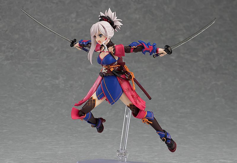 The Miyamoto Musashi figma figure in a jumping or leaping action pose, holding both swords horizontally and showcasing the figure's articulation.
