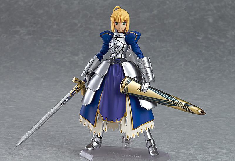 Saber 2.0 figma figure posed with the drawn Excalibur sword in one hand and the ornate scabbard (Avalon) tucked under the other arm.