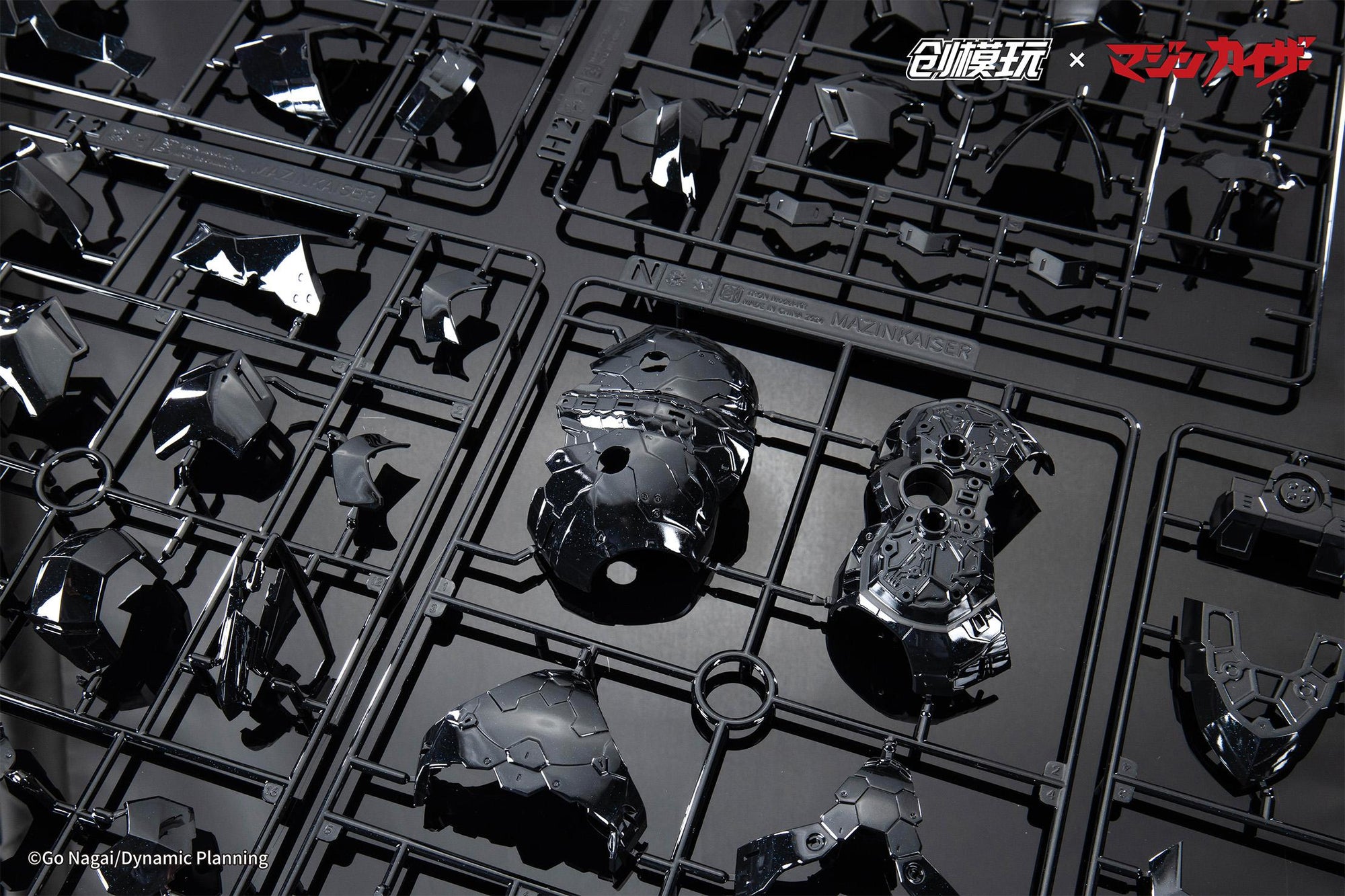 Unassembled black chrome plated model kit runners for the Mazinkaiser mecha armor.