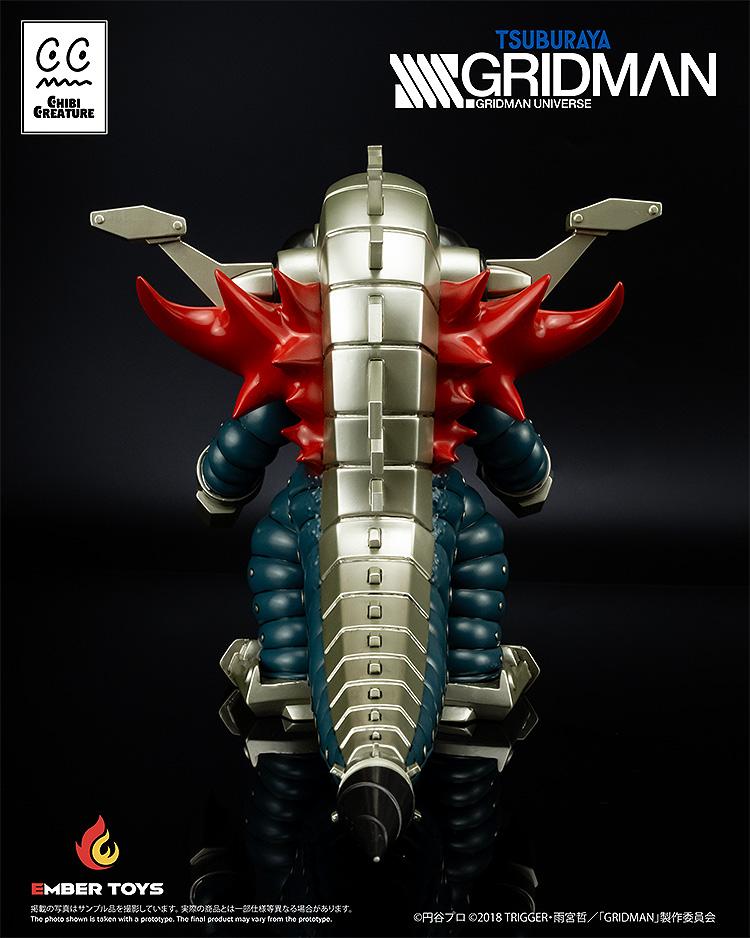 Rear view of the Mecha Ghoulghilas figure emphasizing the silver mechanical dorsal fins and red wing-like spikes.