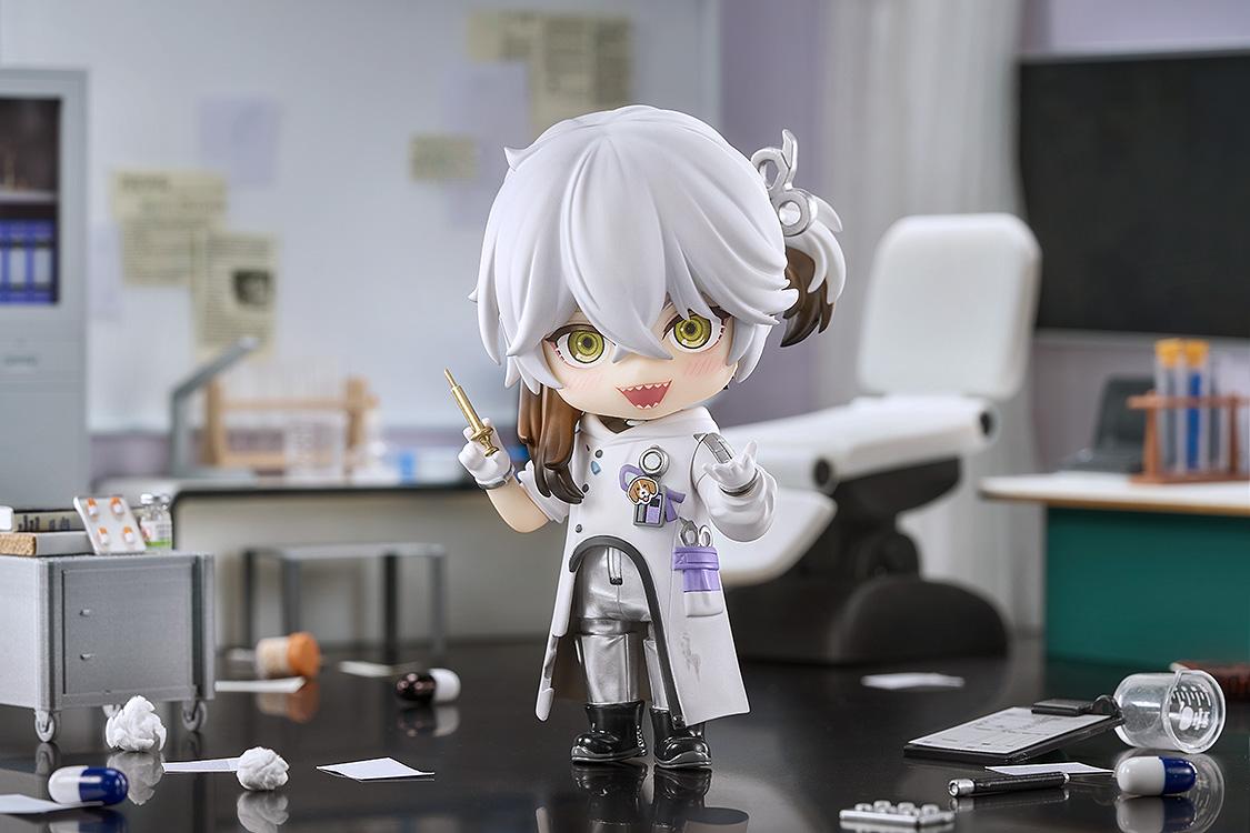 Medicine Pocket Nendoroid with a manic grin and syringe, posed in a highly detailed miniature medical lab diorama with scattered papers and pills.