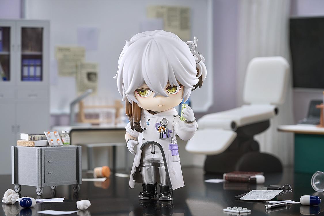 Medicine Pocket Nendoroid with a serious expression holding a green test tube in a miniature laboratory diorama with an examination chair in the background.