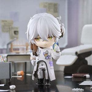 Medicine Pocket Nendoroid with a serious expression holding a green test tube in a miniature laboratory diorama with an examination chair in the background.