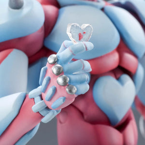 Close-up of the Crazy Diamond figure's hand, delicately holding the small, clear crystal heart accessory.