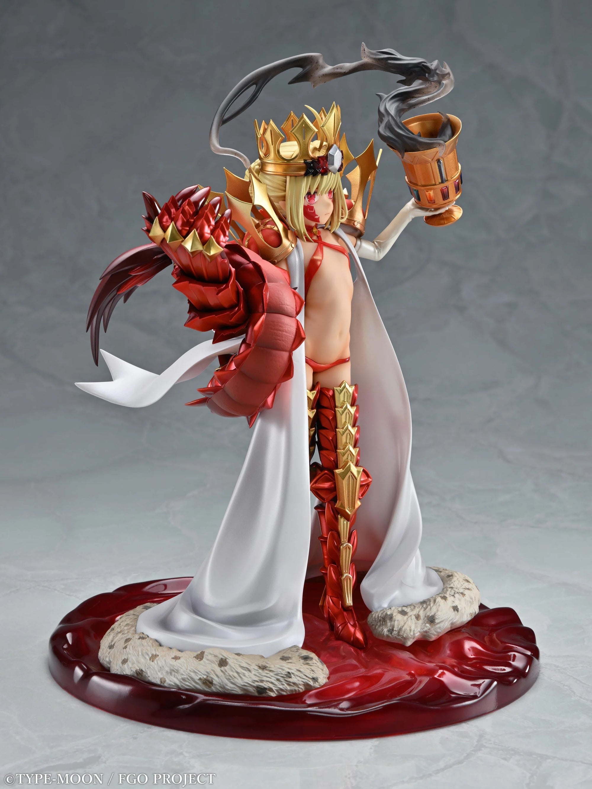 Side profile of the Beast/Draco figure, showcasing the full length of the red and gold armored boot and the flowing white robe.