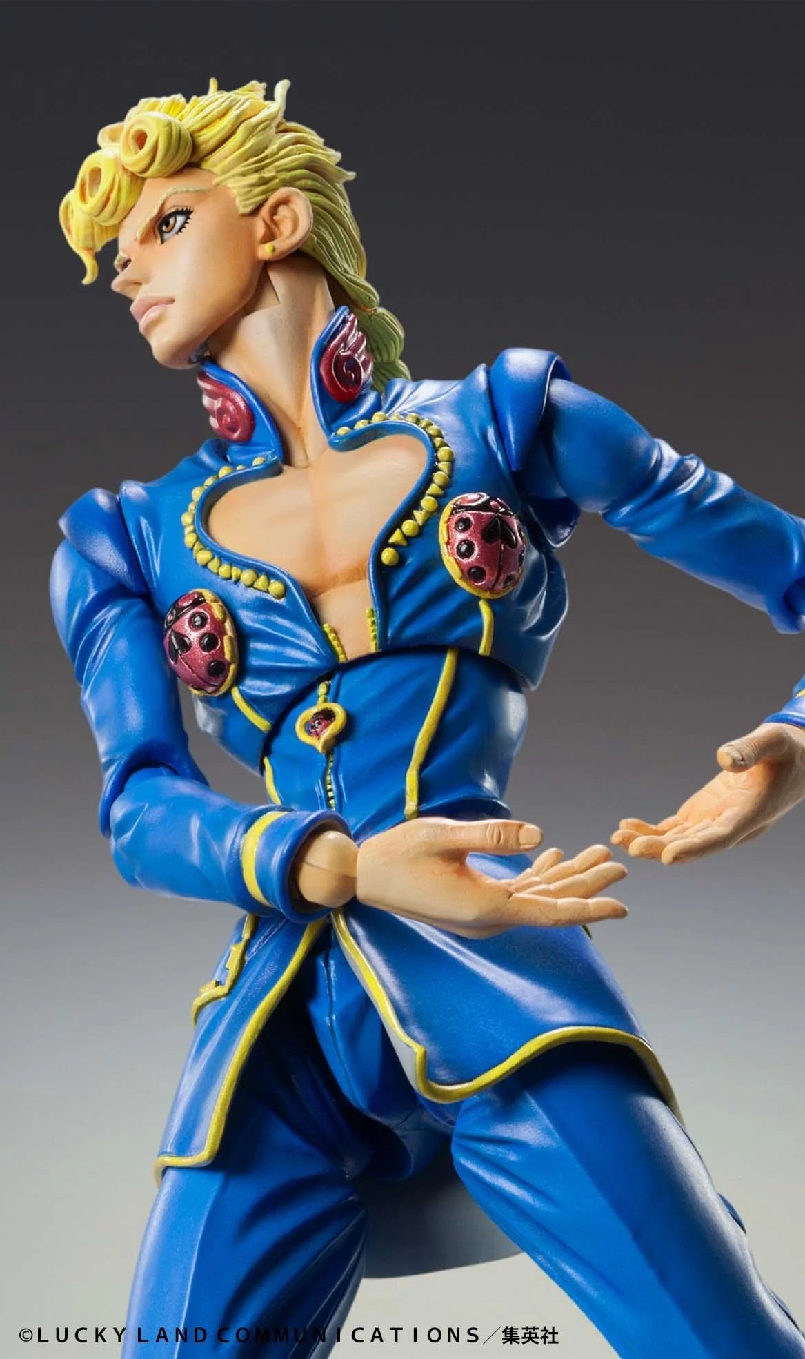 A close-up of the Giorno Giovanna Second figure, showing the detailed sculpt of his face, blonde hair, and his unzipped blue jacket.